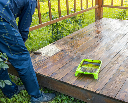 Wooden deck being stained outdoors