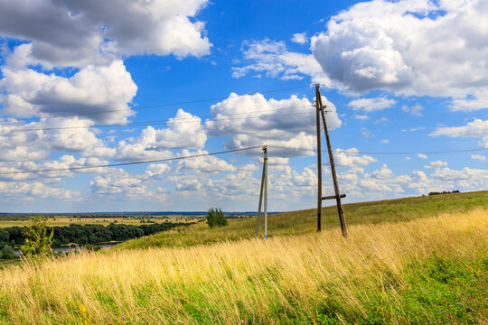 Golden field stretches beneath a bright blue sky