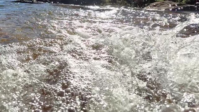 Sunlit Rushing Water and Bubbles in Blue Mountains River