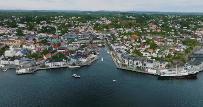 Aerial view of Arendal harbor town Norway coastal city in slow motion showing coastal town