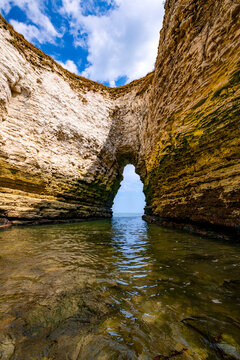 Natural sea arch and narrow rocky inlet in the chalk cliffs of Flamborough Head, East Yorkshire, England, shaped by coastal erosion and opening towards the North Sea.