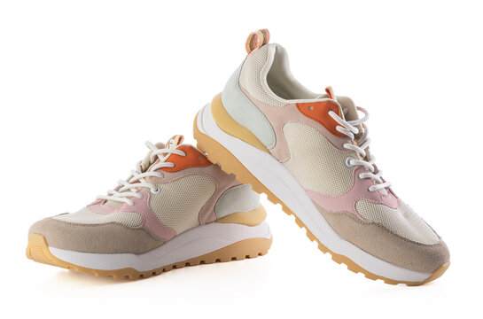 Side view of trendy pastel women sneakers isolated on white background