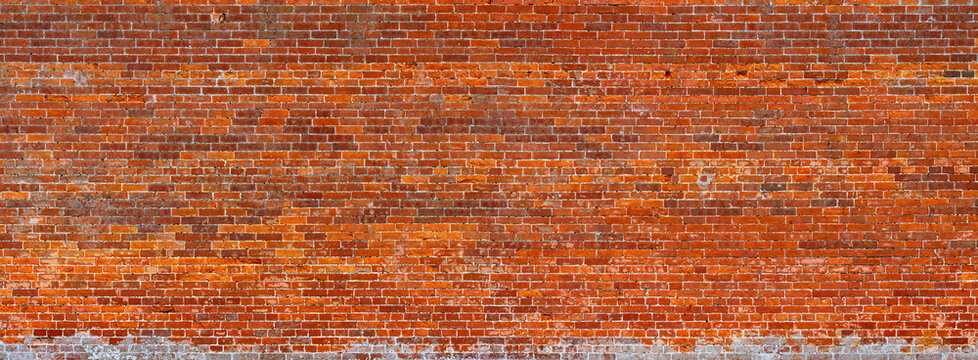 Historic red brick wall in the Walled Garden at Holkham Hall, Norfolk, England. Panoramic wide angle banner.