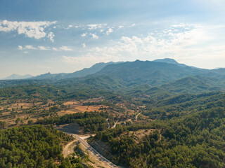 Fototapeta premium Aerial mountain landscape with forest road and rural countryside in Turkey
