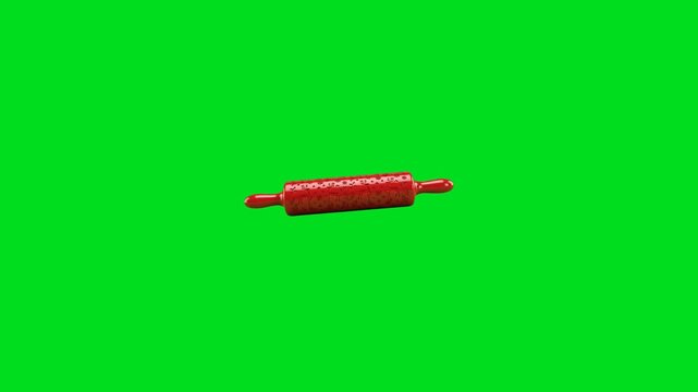 A vibrant red embossed rolling pin isolated against a solid green background