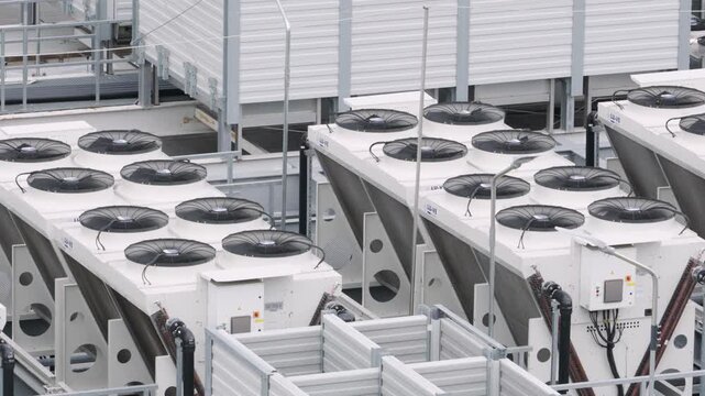 Data center HVAC cooling system fans spinning on rooftop