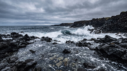 Fototapeta premium Dramatic ultra-realistic ocean landscape viewed from a low angle, dark volcanic rocks protruding through deep blue seawater in the foreground, several stones clearly visible beneath translucent waves