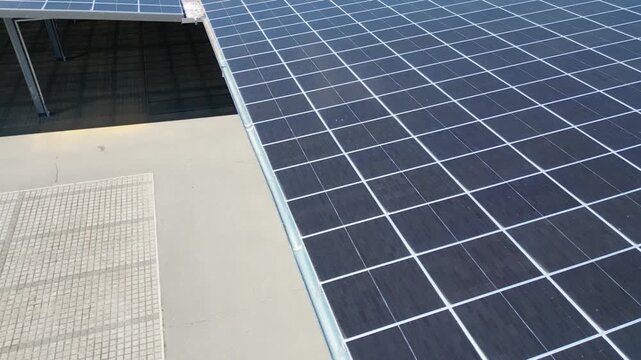 Factory hall with solar panels on roof, renewable energy for industrial production 