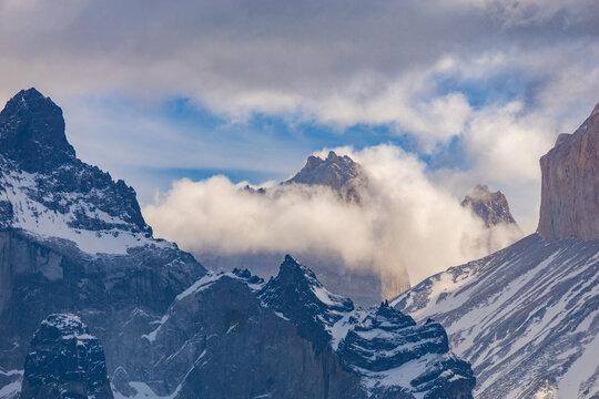 Mountain peaks partly shrouded in fog and clouds, Torres del Paine National Park Chile