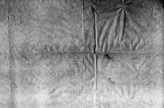 Old worn paper texture with pronounced creases, folds, surface marks and scanning lines, monochrome grain, scratches and visible artifacts.