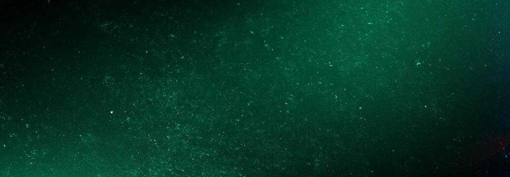 Dark green grunge abstract background texture with vintage film dust effect ideal for moody cinematic poster designs.
