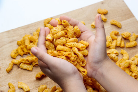 wo Cupped Hands Holding Macaroni Snacks