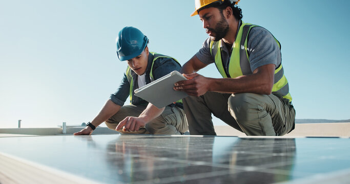 Engineer, tablet and outdoor with solar panel for teamwork, upgrade infrastructure or planning. Men, discussion and photovoltaic system on rooftop for maintenance, clean power or instructions on tech