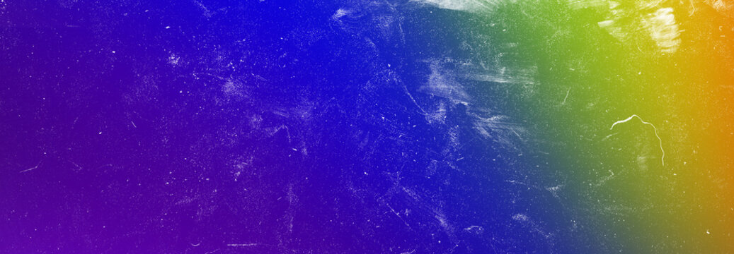 Abstract rainbow gradient background with scratched dust texture suitable for creative design projects and modern art work.