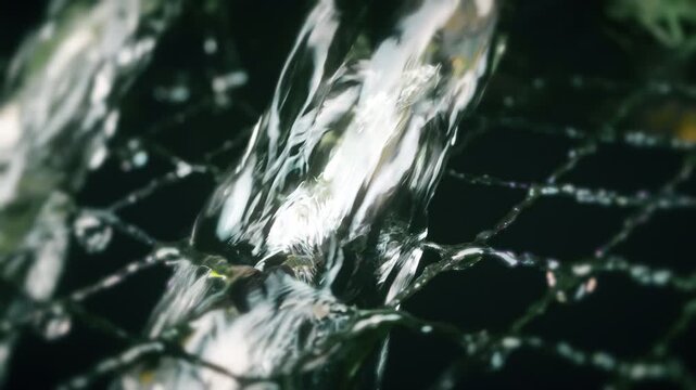 Water flowing onto netting vintage colour pull look close up stock footage