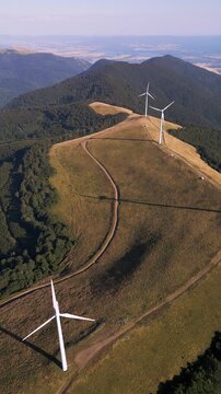 Aerial View of Wind Turbines Windmill Farm on Mountain Ridge at Sunset