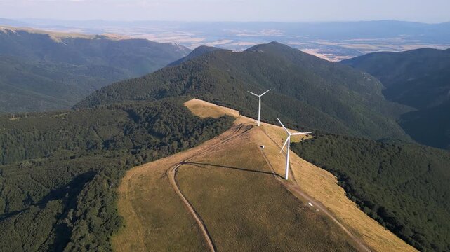 Aerial View of Wind Turbines Windmill Farm on Mountain Ridge at Sunset