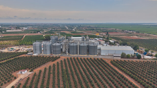 Aerial view of Fallera rice processing factory surrounded by orchards. Valencia, Spain - August 1, 2026.