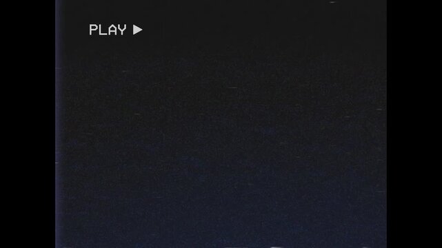 VCR Play Animation with old VHS tape defects, glitches, artifacts and analog noise. Damaged videocassette interference with static TV noise, retro vintage texture and 4K seamless loop overlay.