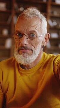 POV of middle-aged man having phone video call, talking with friends at home