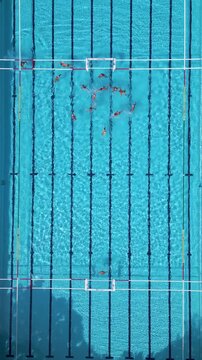 Top Down Aerial View of Water Polo Players Passing Ball During Match Game