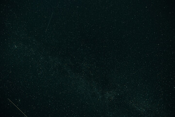 Multiple Perseids meteor streaks falling across dark starry night sky in summer. Concept: cosmic space background © Marya