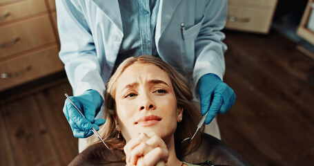 Fototapeta na wymiar Patient, worried and woman with dentist in office, dental health or frightened of medical procedure. Clinic, above and person with stress for teeth exam, scared and checkup for oral care and help