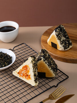 Triangle shaped savory stuffed bread bun resembling onigiri