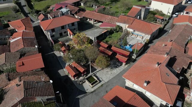 Forxa village rooftops and traditional horreos fill Porqueira, Ourense, Galicia, Spain, aerial establishing overview establishing