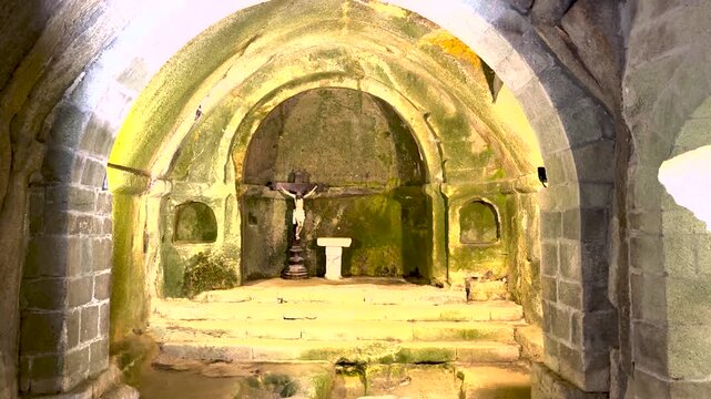 Stone chapel altar and crucifix at San Pedro de Rocas in Esgos, Ourense, Galicia, Spain