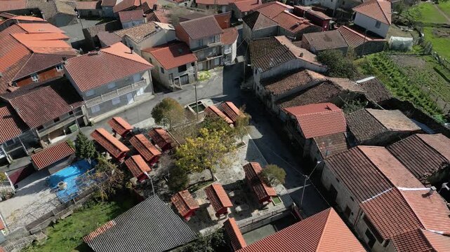 Traditional horreos and village homes cluster in Forxa, Porqueira, Ourense, Galicia, Spain, aerial establishing overview static