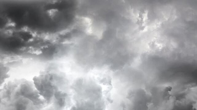 Dark stormy clouds moving rapidly in overcast sky during dramatic weather event.