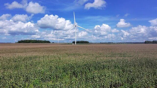 Drone shot of Meadow Lake Wind farm in North Central Indiana with wind turbines turning in the wind over a cornfield