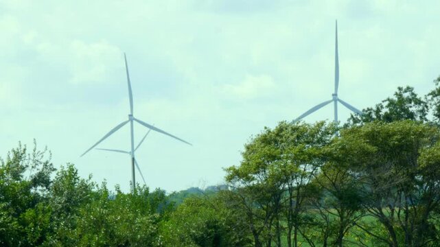 Drone shot of Meadow Lake Wind farm in North Central Indiana with wind turbines turning in the wind over a cornfield