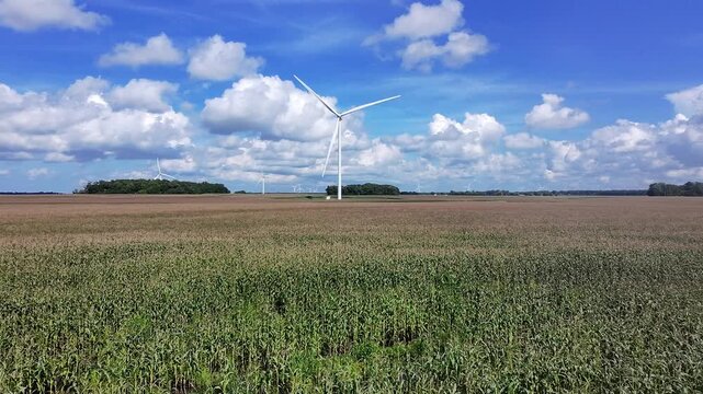 Drone shot of Meadow Lake Wind farm in North Central Indiana with wind turbines turning in the wind over a cornfield