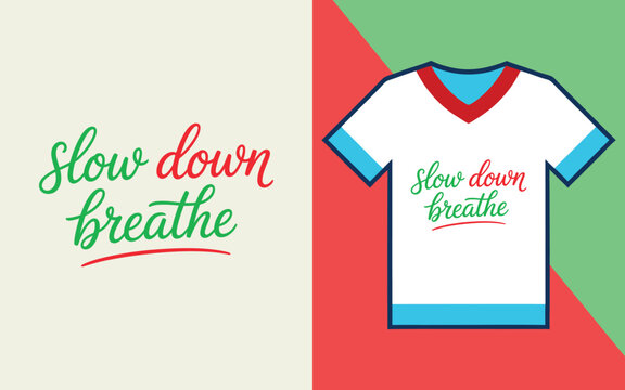 Slow down breathe script lettering on a white t-shirt with red and green geometric background