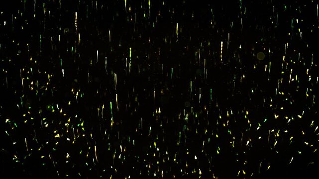 Looping animation of green and yellow light trails moving up and down, particles rise and fall dynamically against a dark abstract background, creating an energetic visual