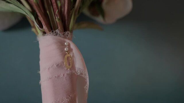 Wedding Bouquet Stems Wrapped In Pink Silk Ribbon With Pearl Pins And Gold Locket Charm