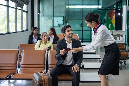 Businessman passenger is showing boarding pass to airline ground crew at departure gate into the airplane for final inspection before boarding to plane