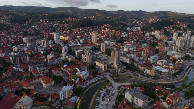 Uzice, Serbia. Establishing Drone Shot of City Center, Buildings and Square at Sunset