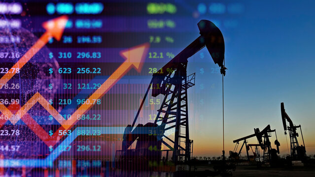 Crude oil industry energy market investment and petroleum refinery economic growth concept. Oil pump jack drilling rigs silhouettes at sunset overlaying digital economic data charts and financial 