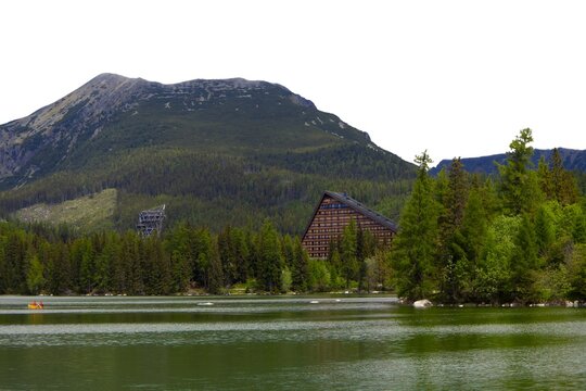 Scenic view of mountain lake Strbske pleso with Hotel Patria and High Tatras mountains in summer, Slovakia