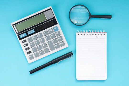 High Angle of Calculator with Pen Notebook and Magnifying Glass for Accounting