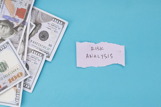 High Angle of Risk Analysis Note Beside Dollar Banknotes on Blue Background