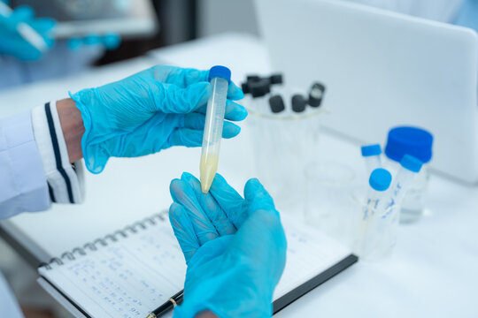 Lab work, Scientist analyzing biological sample for virus detection in modern laboratory.