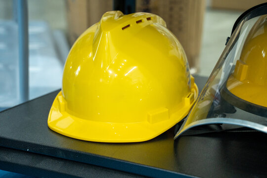 Yellow Safety Hard Hats Placed on a Work Table