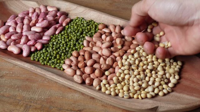 Various beans on the wooden plate