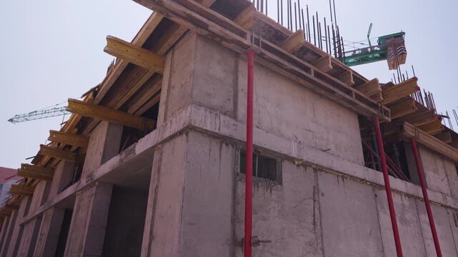 Concrete building structure with formwork and supports under construction