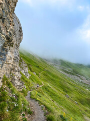 Fototapeta premium Hiking trail in alpine fog above Les Contamines-Montjoie, France