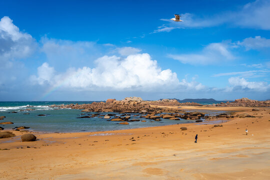 Wide sandy beach overlooking rocky islet in Tregastel, Brittany, France